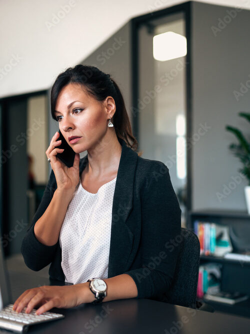 Woman at a laptop with a serious look on her face