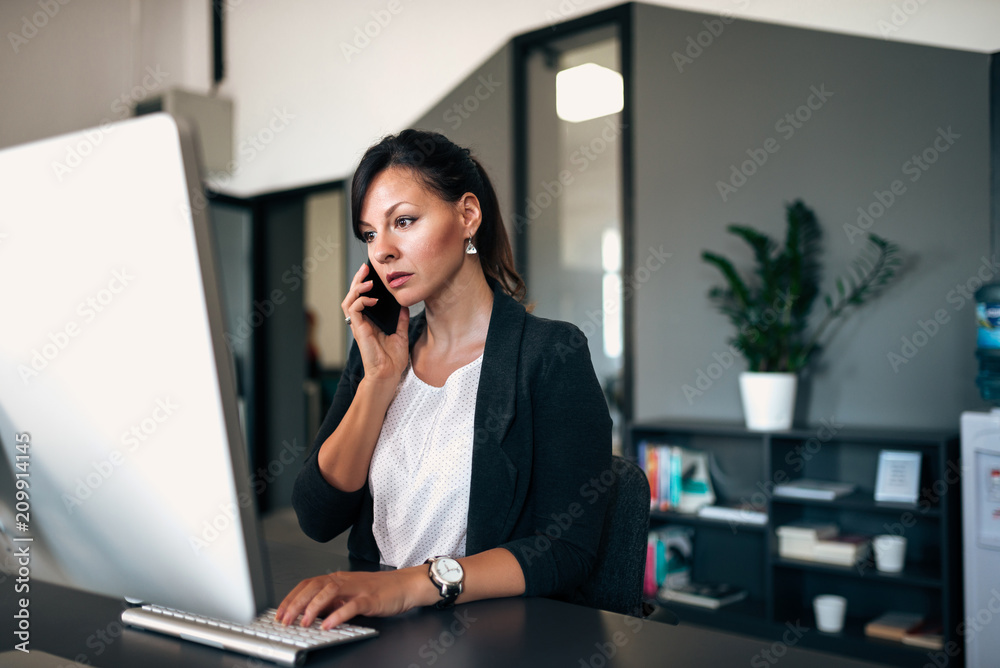 Woman at a laptop with a serious look on her face