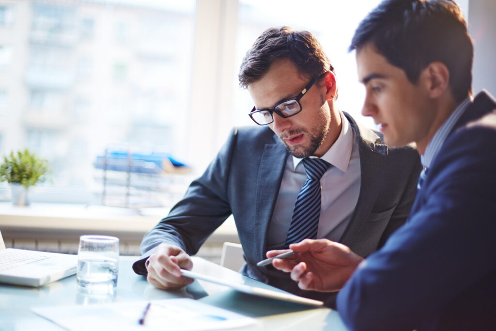 Stock photo of 2 men at a tablet
